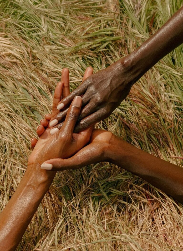 Created for Janubi, a shea butter company rooted in African diasporic traditions of care and run by South Sudanese-American model Kouth Weil, this image frames touch as inheritance. Janubi’s folklore—drawn from the story of a Sudanese princess said to hold the secret to eternal youth—centers matrilineal knowledge passed intergenerationally, from grandmothers to daughters to granddaughters, hand to hand, body to body.Trotter’s photograph distills this lineage into a quiet, tactile exchange: layered Black hands resting in tall grass, skin meeting skin, moisture catching the light. There is no hierarchy here—only reciprocity. Echoing broader themes of care, divinity, and presence, the image insists that Black existence and love have long been sustained through touch as a form of labor that nurtures rather than extracts.